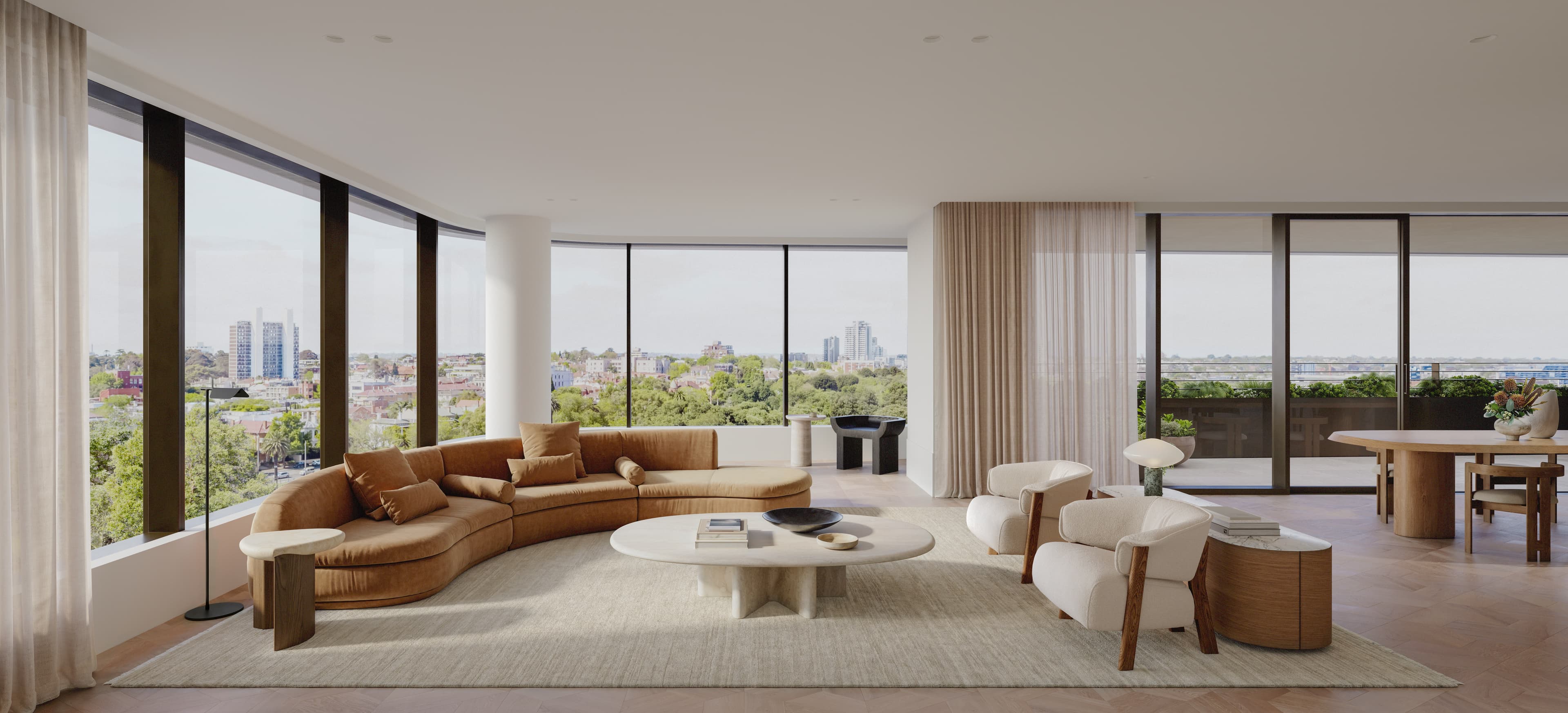 Living room with a curved sofa and floor-to-ceiling windows overlooking a green city skyline